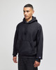 A black hooded sweatshirt with a front pocket, featuring a logo on the sleeve.