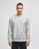 A grey Champion Reverse Weave® adult crew sweatshirt with long sleeves and a logo on the sleeve.