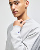 A grey Champion Reverse Weave® adult crew sweatshirt, featuring a small logo on the sleeve.