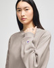 A model wearing a grey Champion Reverse Weave® adult crew sweatshirt, showcasing a casual style.