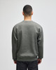 A grey adult crewneck sweatshirt is displayed from the back, featuring long sleeves and a simple design.