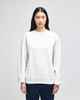 A white crewneck sweatshirt made from Champion Powerblend® fabric, featuring a logo on the sleeve.