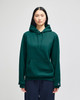 A green hooded sweatshirt featuring a front pocket and a logo on the sleeve.