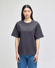 A black hooded sweatshirt featuring a logo, displayed on a model against a plain background.