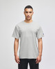 A grey short-sleeve t-shirt featuring a logo on the sleeve, displayed on a model.