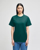 A green Champion Adult Short-Sleeve T-Shirt displayed on a model, featuring a logo on the sleeve.