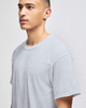 A grey short-sleeve t-shirt on a male model, featuring a relaxed fit and a simple design.