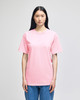 A pink short-sleeve t-shirt displayed on a model, featuring a basic design and a logo on the front.