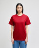 A red Champion adult short-sleeve t-shirt displayed on a model, featuring a logo on the sleeve.