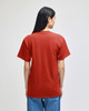 A red Champion adult short-sleeve t-shirt viewed from the back, worn with blue jeans. Features a logo.