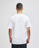A man wearing a plain white short-sleeve t-shirt, viewed from the back, with a logo on the shirt.