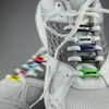 A pair of white sneakers featuring colourful luxury shoelace charms with a custom design.