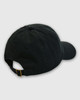 A black polo cap with a curved brim and an adjustable strap at the back, featuring a logo.