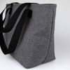 A grey lunch bag with black straps, featuring a simple design and an external logo.