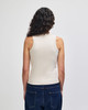 A fitted women's tank top in a light beige colour, featuring a sleeveless design and fitted silhouette.