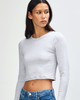 A grey long-sleeve crop fitted T-shirt for women, featuring a snug fit and a simple design, with branding.