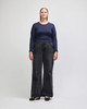 A fitted long-sleeve crop T-shirt in navy, paired with wide-leg black jeans. The model stands upright against a plain background.