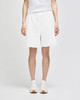 White cotton gym shorts with a relaxed fit and an elastic waistband, featuring branding.