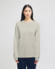 A light grey long-sleeve t-shirt for adults, featuring a branding logo. Modelled by a person with long hair.