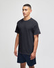 A model wearing a black short sleeve t-shirt with a logo, paired with navy shorts.