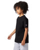 A black Champion youth jersey short sleeve t-shirt displayed on a model with curly hair, wearing grey shorts.