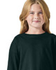 A child wearing a black long sleeve t-shirt, featuring a round neckline and relaxed fit. The shirt has a logo.