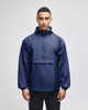 A navy packable anorak jacket with a hood and front pocket, featuring a logo on the chest.