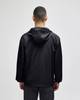 A black packable anorak jacket with a hood, viewed from the back, featuring a logo on the neck area.