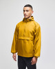 A packable anorak jacket in mustard yellow, featuring a hood and a front pocket, with a logo on the sleeve.