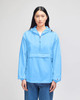 A packable anorak jacket in sky blue, featuring a front pocket and a hood, worn by a model standing upright.