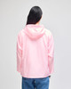 A pink packable anorak jacket featuring a hood, viewed from the back, with a logo on the sleeve.