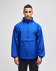 A blue packable anorak jacket with a hood and front pocket, featuring a logo on the sleeve.