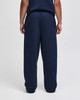 Navy blue open-bottom fleece pants with pockets, featuring a relaxed fit, viewed from the back.