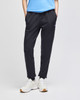 A pair of black fleece jogger pants with side pockets, styled with a light blue top and white shoes.