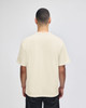 A beige Champion Adult Heritage Jersey T-Shirt viewed from the back, featuring short sleeves and a logo.