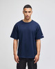 A navy blue Champion Adult Heritage Jersey T-Shirt on a model, featuring a logo on the sleeve.