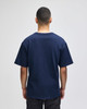 A navy blue Champion Adult Heritage Jersey T-Shirt viewed from the back. It features short sleeves and a relaxed fit.