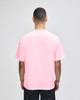 A pink Champion adult heritage jersey t-shirt displayed from the back view on a male model.