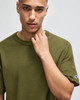 An olive green Champion Adult Heritage Jersey T-Shirt with a branded logo on the sleeve.