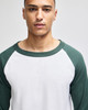 A raglan baseball t-shirt featuring a white body and green sleeves, designed for adults. Includes a logo.
