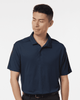 A navy blue men's polo shirt featuring short sleeves and a collar. The garment includes a logo.