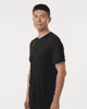 A black men's performance t-shirt displayed on a model, featuring a fitted design and a logo.