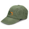 A vintage washed cap in olive green with a logo on the front. The cap features a curved brim and textured fabric.