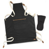 A dark denim apron with cream straps and a pocket, accompanied by a matching dark oven mitt.