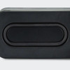 A rectangular black bass speaker featuring a smooth surface and a central oval design element.