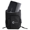 A black backpack with a large compartment containing a grey picnic blanket and an emblem on the front.