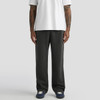 Relax Faded cuffless track pants in black, styled with a white T-shirt and navy shoes, featuring a logo.