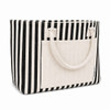 A striped tote bag with black and cream colours, featuring a front pocket and two top handles.