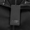 A black softshell jacket with a branded tag attached near the collar. The fabric appears soft and warm.