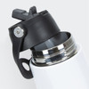 A drink bottle with a white body and a black lid, featuring a sip spout and a metal opening.